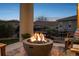 Relax by the fire pit on the patio while enjoying the beautiful evening sky at 9724 Cantabria Pt, Lone Tree, CO 80124