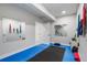Home gym features padded floors, mirrors and storage space for equipment at 9724 Cantabria Pt, Lone Tree, CO 80124
