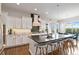 Bright kitchen featuring an island with seating, stainless steel appliances, and modern finishes at 9724 Cantabria Pt, Lone Tree, CO 80124