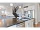Open kitchen with stainless steel appliances, island with seating, and modern finishes at 9724 Cantabria Pt, Lone Tree, CO 80124