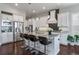 Bright kitchen showcases stainless steel appliances, white cabinets, granite countertops, and a functional island at 9724 Cantabria Pt, Lone Tree, CO 80124