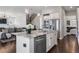 Island in the kitchen includes granite countertops, stainless steel dishwasher, and views into other rooms at 9724 Cantabria Pt, Lone Tree, CO 80124