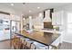 Modern kitchen featuring a large island with seating, stainless steel appliances, and stylish lighting at 9724 Cantabria Pt, Lone Tree, CO 80124