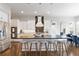 Open kitchen design featuring a large island with seating, stainless steel appliances, and modern decor at 9724 Cantabria Pt, Lone Tree, CO 80124