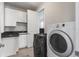 Laundry room featuring modern appliances, ample cabinet space, and tiled flooring at 9724 Cantabria Pt, Lone Tree, CO 80124