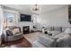 Inviting living room featuring a fireplace, custom built-ins, stylish lighting, and comfortable seating at 9724 Cantabria Pt, Lone Tree, CO 80124