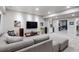 Spacious living room boasts a large gray couch, entertainment center and an open floorplan to another room at 9724 Cantabria Pt, Lone Tree, CO 80124