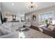 Open-concept living room showcases a large sectional sofa, wood floors, and natural light at 9724 Cantabria Pt, Lone Tree, CO 80124