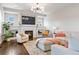 Living room with a modern fireplace, TV, light gray sofas and lots of natural light at 9724 Cantabria Pt, Lone Tree, CO 80124