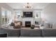 Cozy living room with a fireplace, custom built-ins, modern lighting, and comfortable seating at 9724 Cantabria Pt, Lone Tree, CO 80124