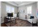 Bright home office featuring large windows and a comfortable sitting area at 9724 Cantabria Pt, Lone Tree, CO 80124