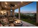 Spacious covered patio featuring comfortable seating, a fire pit, and an outdoor dining area at 9724 Cantabria Pt, Lone Tree, CO 80124