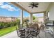 Covered patio boasts a ceiling fan, ample seating, a grill and a beautiful view at 9724 Cantabria Pt, Lone Tree, CO 80124