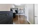 Walk-in closet with custom shelving, racks for hanging, and dark wood floors at 9724 Cantabria Pt, Lone Tree, CO 80124