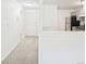 Hallway view to kitchen featuring stainless steel appliances and light gray cabinetry at 2880 S Locust St # 109S, Denver, CO 80222