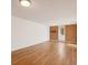 Open living room with plenty of space, featuring laminate flooring and brick accent wall at 2880 S Locust St # 109S, Denver, CO 80222