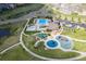 Aerial view of a community pool and playground area with a recreation center and ample parking at 8726 Holman Cir, Arvada, CO 80005