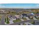 Aerial view of homes in a suburban neighborhood with lush landscaping and nearby lake at 8726 Holman Cir, Arvada, CO 80005