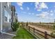 Picturesque backyard with a wooden fence bordering walking trail and lush landscaping at 8726 Holman Cir, Arvada, CO 80005