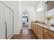 Bathroom featuring a large vanity with granite counters, glass shower door, and access to main bedroom at 8726 Holman Cir, Arvada, CO 80005