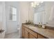 Bathroom features a vanity with granite countertop, ample storage space, and modern fixtures at 8726 Holman Cir, Arvada, CO 80005