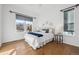 Comfortable bedroom with hardwood floors, white walls, and lots of natural light at 8726 Holman Cir, Arvada, CO 80005