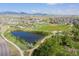 Aerial view of community featuring pond, park, baseball field, pool, and playground at 8726 Holman Cir, Arvada, CO 80005