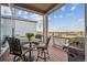 Enjoy outdoor dining on this covered deck with table, chairs, grill, and beautiful views at 8726 Holman Cir, Arvada, CO 80005