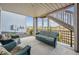 Relax on this covered patio featuring wicker furniture, a view of the backyard, and convenient access to stairs at 8726 Holman Cir, Arvada, CO 80005
