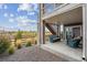 Comfortable covered patio with outdoor seating, a view of the yard, and access to upper-level stairs at 8726 Holman Cir, Arvada, CO 80005