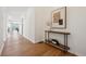 Bright entryway featuring hardwood floors and a decorative table with art at 8726 Holman Cir, Arvada, CO 80005