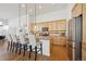 Open kitchen with a breakfast bar, stainless steel appliances, and wooden cabinets at 8726 Holman Cir, Arvada, CO 80005