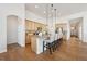 Bright kitchen featuring a central island with bar stool seating and modern pendant lighting at 8726 Holman Cir, Arvada, CO 80005