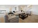 Well-lit living room features neutral tones, ample seating, stylish decor and a staircase at 8726 Holman Cir, Arvada, CO 80005