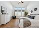 Bright main bedroom with neutral decor, hardwood floors, and large windows providing natural light at 8726 Holman Cir, Arvada, CO 80005