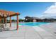Community swimming pool with lounge chairs, pergolas, and a modern pool house at 8726 Holman Cir, Arvada, CO 80005