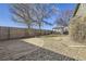 Large backyard featuring a pergola-covered patio, a spacious lawn, and a wooden fence at 1542 Cherry St, Brighton, CO 80601