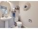 Neat powder room with a pedestal sink, modern fixtures, and decorative accents at 1542 Cherry St, Brighton, CO 80601
