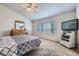 Cozy bedroom featuring a comfortable bed, a window, and a dresser with a mirror at 1542 Cherry St, Brighton, CO 80601