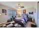 Comfortable bedroom with a ceiling fan and ample natural light from the window at 1542 Cherry St, Brighton, CO 80601