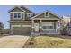 Charming two-story home with a covered porch, stone accents, and a well-maintained lawn at 1542 Cherry St, Brighton, CO 80601