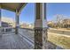 Covered front porch featuring stone pillars, a patterned tile floor, and white railings at 1542 Cherry St, Brighton, CO 80601
