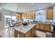 Bright kitchen with stainless steel appliances, granite countertops, and an island with bar seating at 1542 Cherry St, Brighton, CO 80601