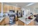 Modern kitchen with stainless steel appliances, wood cabinets, and an island with granite countertops at 1542 Cherry St, Brighton, CO 80601