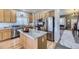 Updated kitchen with stainless steel appliances, granite countertops, and a view into the living area at 1542 Cherry St, Brighton, CO 80601