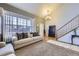 Inviting living room with high ceilings, cozy sofa, and staircase at 1542 Cherry St, Brighton, CO 80601