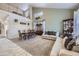 Spacious living room with high ceilings, neutral carpet, and a dining area at 1542 Cherry St, Brighton, CO 80601