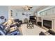 Comfortable living room with plush seating, fireplace, and ceiling fan at 1542 Cherry St, Brighton, CO 80601
