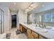 Primary bathroom with double sinks, a large mirror, and a separate shower at 1542 Cherry St, Brighton, CO 80601
