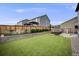 Backyard with green grass, patio furniture, and a well-maintained fence ensuring privacy at 16673 E Virginia Ave, Aurora, CO 80017